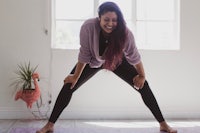 a woman doing yoga in a room with a window